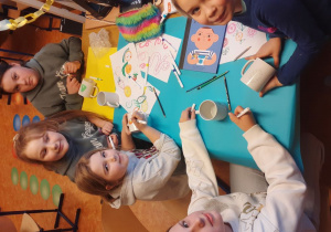 Dziewczynki z klasy 1 i 4 przy wykonywaniu pracy z projektu ,,O sztuce Picassa...".